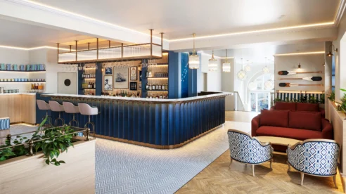 Elegant hotel lounge with cosy seating and a stylish bar, inviting for relaxation and conversation.