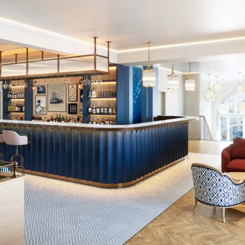 Elegant hotel lounge with cosy seating and a stylish bar, inviting for relaxation and conversation.