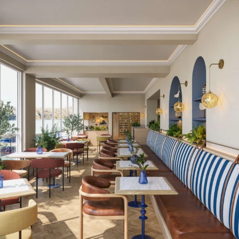 Elegant restaurant with harbour views, featuring blue-striped seating and warm wooden accents.