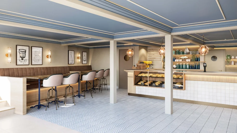 Family enjoying pastries and coffee at a bright hotel café counter with comfy seating and coastal decor