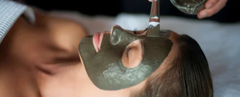 Relaxing spa treatment with a rejuvenating face mask applied by a skilled therapist.