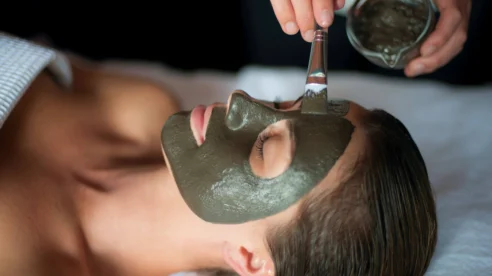 Relaxing spa treatment with a rejuvenating face mask applied by a skilled therapist.