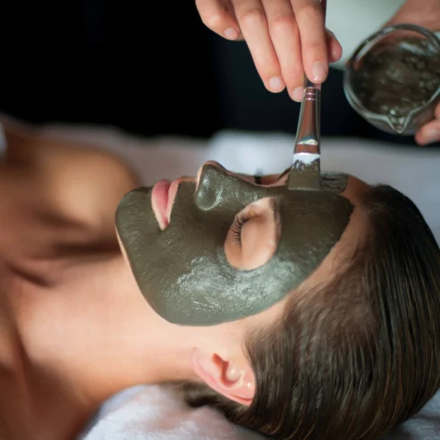 Relaxing spa treatment with a rejuvenating face mask applied by a skilled therapist.