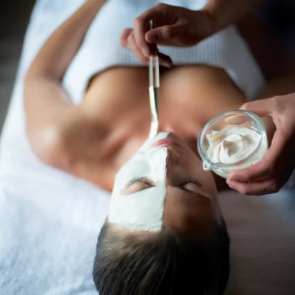 Relaxing spa facial treatment in luxurious hotel setting.