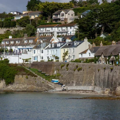 Charming coastal village with white houses overlooking the sea, perfect for a family holiday.