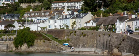 Charming coastal village with white houses overlooking the sea, perfect for a family holiday.