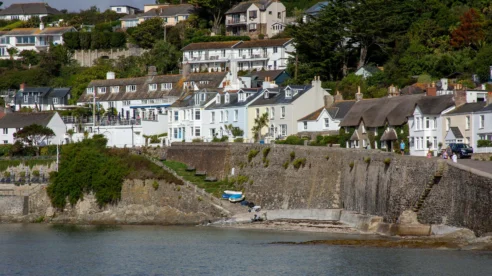 Charming coastal village with white houses overlooking the sea, perfect for a family holiday.
