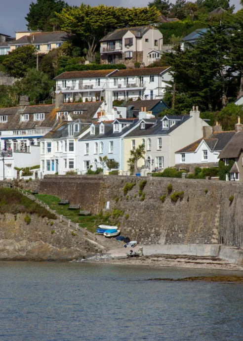 Charming coastal village with white houses overlooking the sea, perfect for a family holiday.