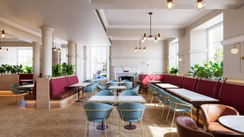 Stylish hotel dining area with elegant tables and plush seating, spacious and welcoming.
